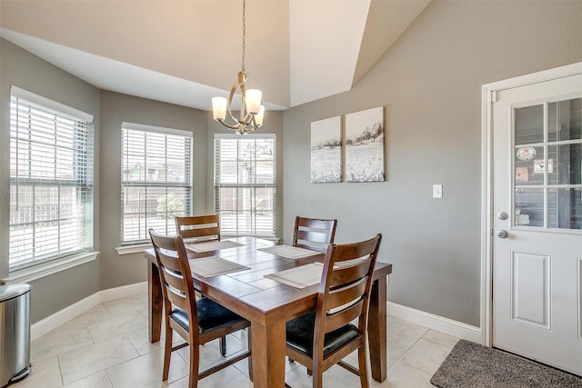 dining area featuring an inviting chandelier, light tile patterned flooring, baseboards, and vaulted ceiling