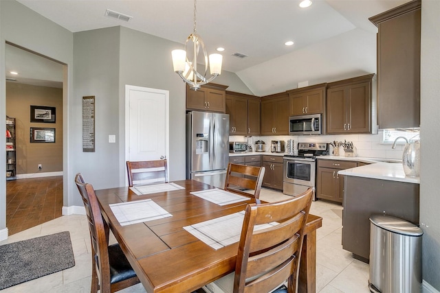 kitchen featuring light countertops, visible vents, appliances with stainless steel finishes, a sink, and light tile patterned floors