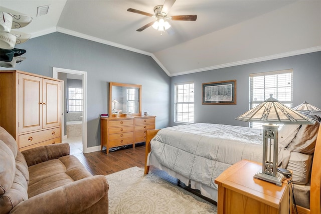 bedroom with visible vents, light wood-style flooring, vaulted ceiling, and crown molding