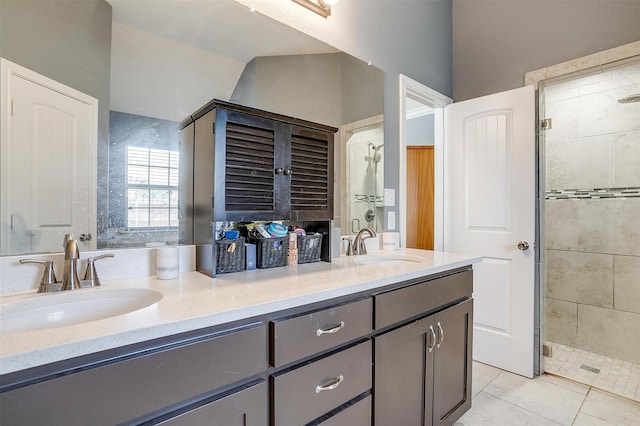 bathroom featuring double vanity, a sink, and a stall shower