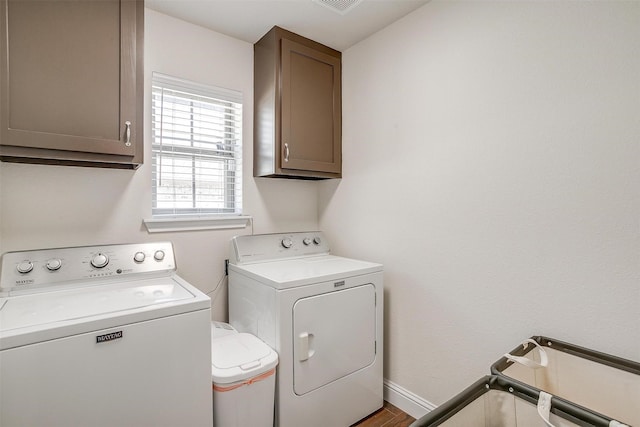 laundry area featuring independent washer and dryer, cabinet space, baseboards, and visible vents