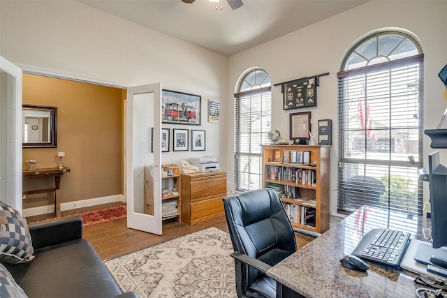 home office featuring baseboards, wood finished floors, and ceiling fan