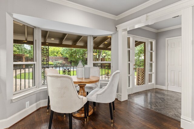 kitchen with cream cabinets, decorative backsplash, a sink, and range with two ovens