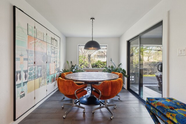 dining room with wood finished floors and a healthy amount of sunlight