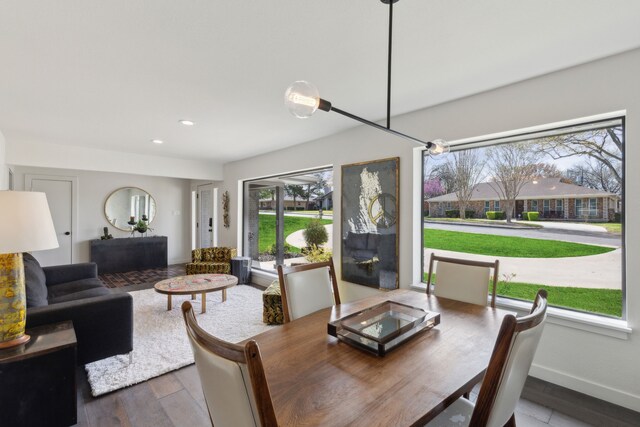 dining space with recessed lighting, baseboards, and wood finished floors