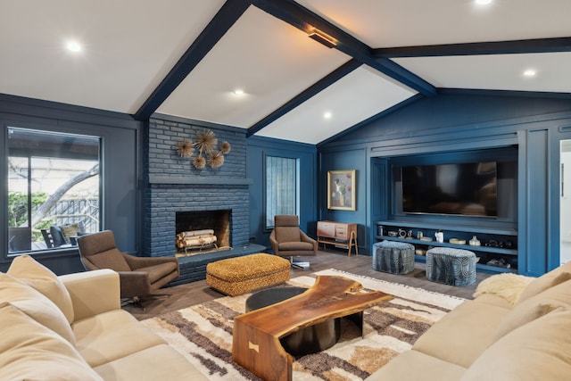 living room featuring lofted ceiling with beams, wood finished floors, a decorative wall, and a brick fireplace