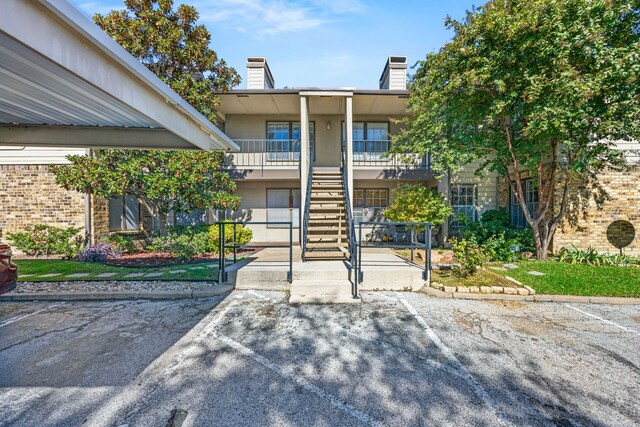 5300 Keller Springs Rd Unit 2044, Dallas, TX 75248 - view of property with uncovered parking and stairway