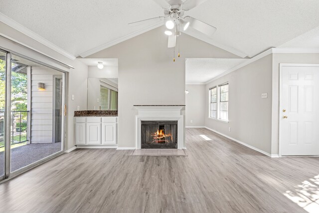 5300 Keller Springs Rd Unit 2044, Dallas, TX 75248 - unfurnished living room featuring vaulted ceiling, a textured ceiling, a ceiling fan, a fireplace with flush hearth, and light wood-style floors