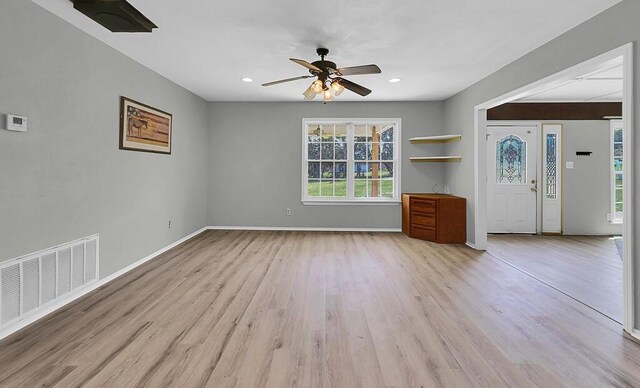 unfurnished living room with recessed lighting, light wood finished floors, visible vents, a ceiling fan, and baseboards