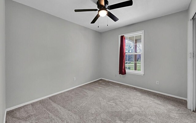 unfurnished room with carpet, baseboards, and ceiling fan