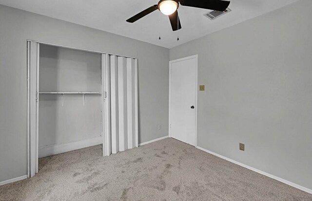 unfurnished bedroom with a ceiling fan, a closet, baseboards, carpet flooring, and visible vents
