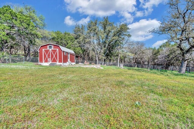 view of yard featuring an outbuilding and a fenced backyard