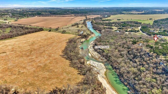 birds eye view of property featuring a wooded view