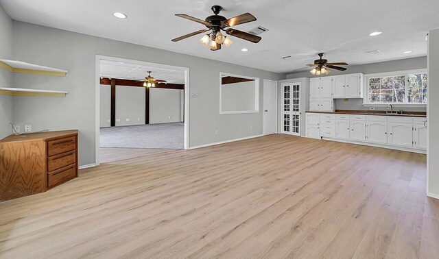 unfurnished living room featuring recessed lighting, light wood-style flooring, visible vents, and a ceiling fan
