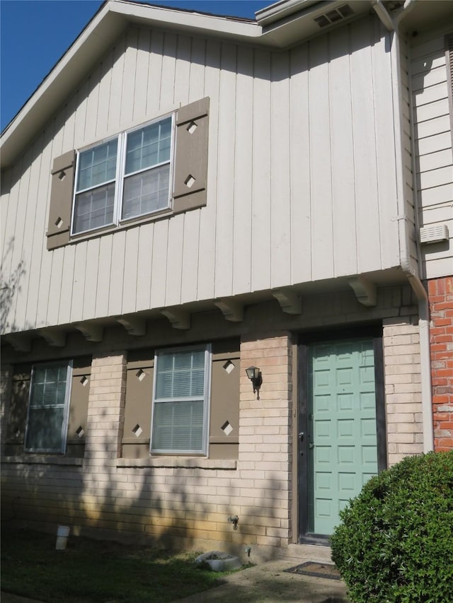 view of property featuring brick siding