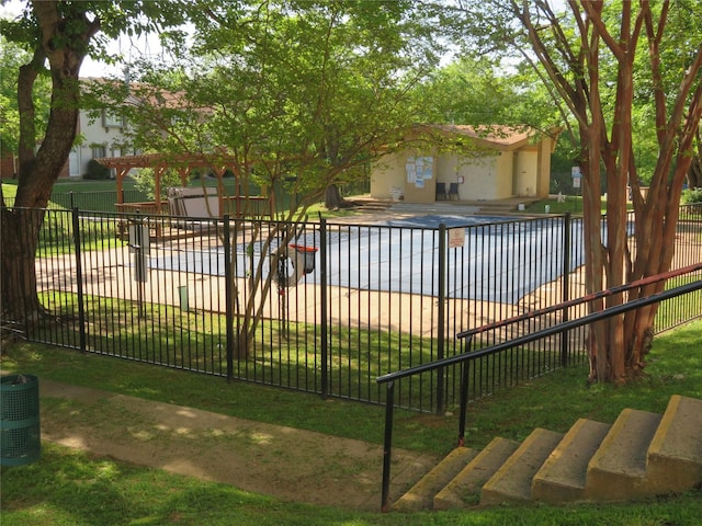 view of swimming pool featuring fence