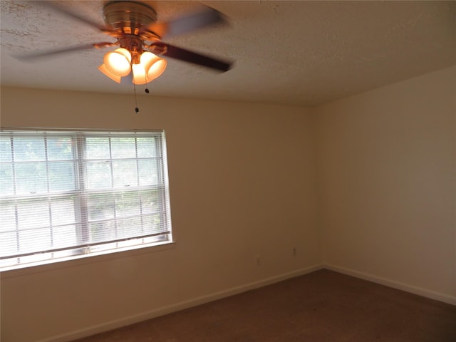 carpeted empty room featuring baseboards, a textured ceiling, and ceiling fan