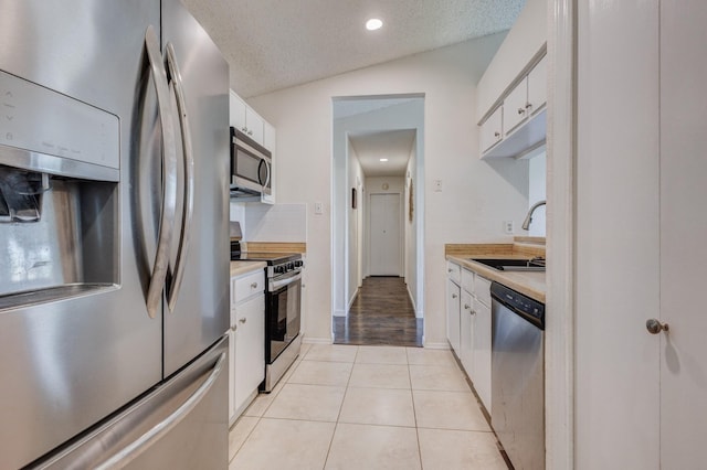 1201 High Valley Dr, Garland, TX 75041 - kitchen with light countertops, appliances with stainless steel finishes, a sink, and white cabinetry