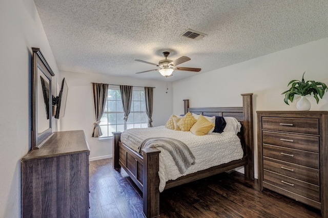 1201 High Valley Dr, Garland, TX 75041 - bedroom with baseboards, a textured ceiling, a ceiling fan, dark wood-type flooring, and visible vents