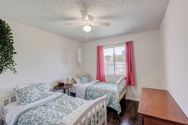 1201 High Valley Dr, Garland, TX 75041 - bedroom featuring a textured ceiling, ceiling fan, and dark wood-style floors