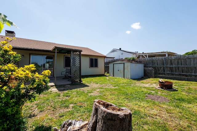 1201 High Valley Dr, Garland, TX 75041 - view of yard featuring a fire pit, a storage shed, fence, a patio, and an outbuilding