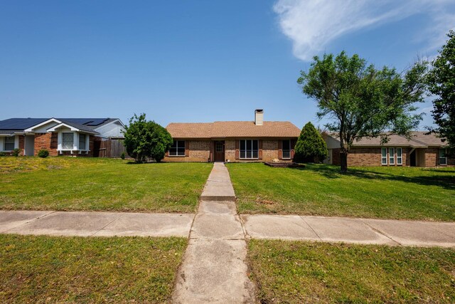1201 High Valley Dr, Garland, TX 75041 - ranch-style home with a chimney, a front lawn, and brick siding