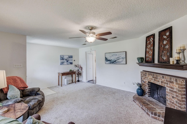 1201 High Valley Dr, Garland, TX 75041 - carpeted living area with visible vents, a textured ceiling, a ceiling fan, and a brick fireplace