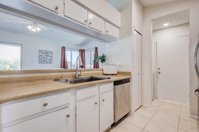 1201 High Valley Dr, Garland, TX 75041 - kitchen with stainless steel dishwasher, white cabinetry, a ceiling fan, light countertops, and a sink