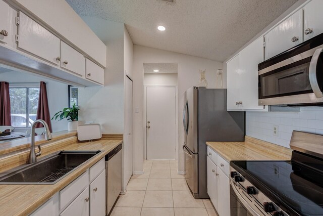1201 High Valley Dr, Garland, TX 75041 - kitchen with a sink, light countertops, white cabinetry, stainless steel appliances, and backsplash
