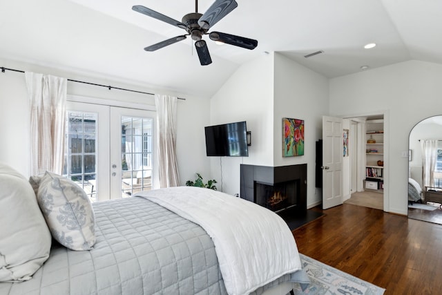 6926 Santa Monica Dr, Dallas, TX 75223 - bedroom with french doors, wood finished floors, access to exterior, a multi sided fireplace, and vaulted ceiling