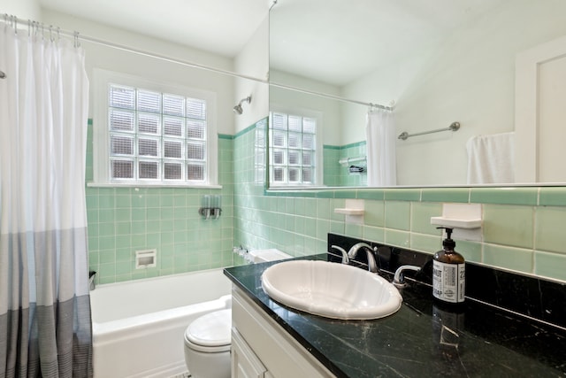 6926 Santa Monica Dr, Dallas, TX 75223 - bathroom featuring shower / tub combo, toilet, vanity, and tile walls