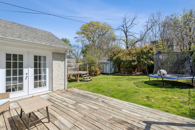 6926 Santa Monica Dr, Dallas, TX 75223 - wooden terrace with an outbuilding, french doors, a trampoline, a yard, and a storage shed