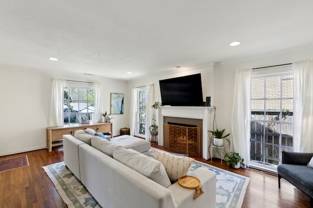 6926 Santa Monica Dr, Dallas, TX 75223 - living room with a warm lit fireplace, dark wood-type flooring, baseboards, and recessed lighting