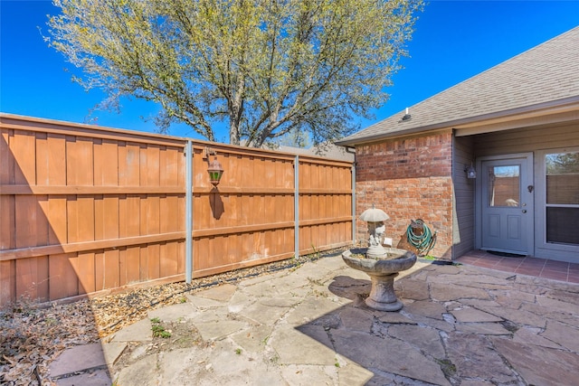 view of patio featuring fence