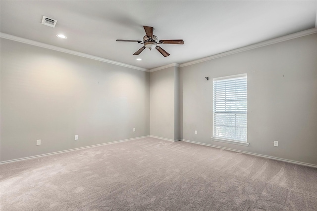 empty room with baseboards, visible vents, ceiling fan, and ornamental molding