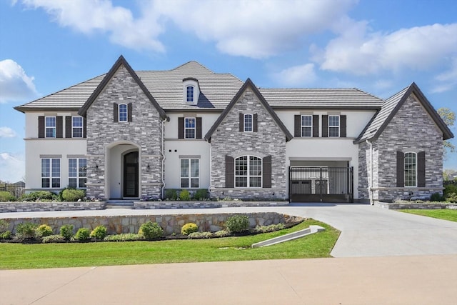 3905 Dashiell Dr, Flower Mound, TX 75022 - french country home with stucco siding, stone siding, concrete driveway, and an attached garage