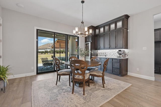 3905 Dashiell Dr, Flower Mound, TX 75022 - dining area with a chandelier, baseboards, and light wood-type flooring