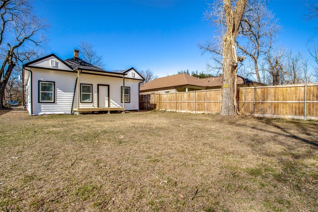 2316 Marburg St, Dallas, TX 75215 - rear view of house featuring a chimney, fence, and a yard