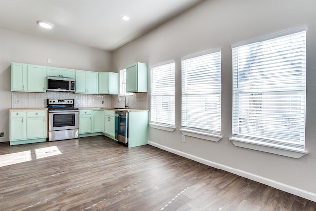 2316 Marburg St, Dallas, TX 75215 - kitchen featuring baseboards, backsplash, a sink, and stainless steel appliances