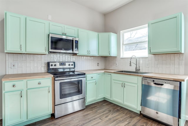 2316 Marburg St, Dallas, TX 75215 - kitchen featuring baseboards, tasteful backsplash, a sink, and stainless steel appliances