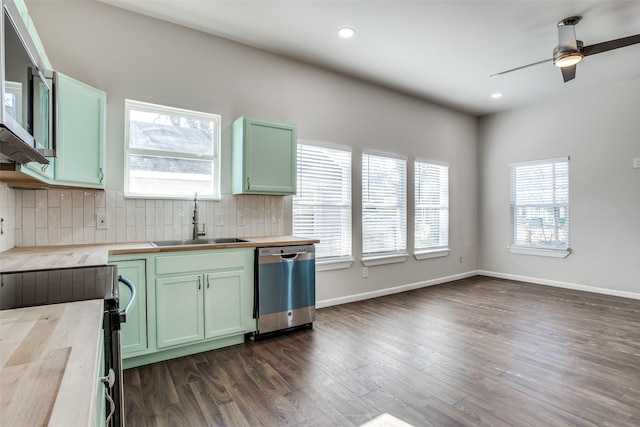 2316 Marburg St, Dallas, TX 75215 - kitchen featuring green cabinets, stainless steel appliances, dark wood finished floors, a sink, and backsplash
