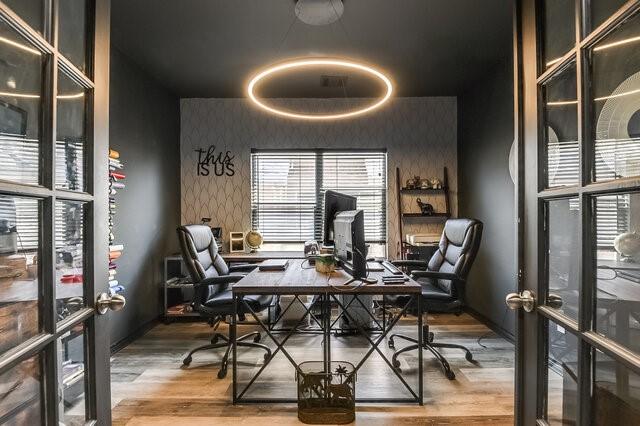 office space featuring baseboards, wallpapered walls, wood finished floors, and french doors