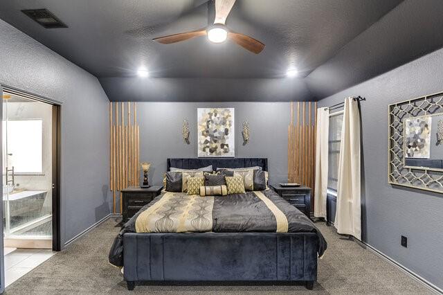 bedroom featuring carpet floors, lofted ceiling, and visible vents