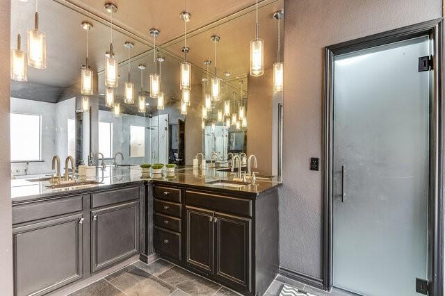 full bathroom with double vanity and a sink