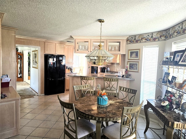 dining area featuring a textured ceiling and light tile patterned floors