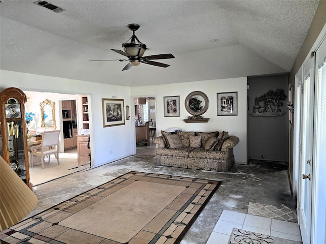 living room featuring vaulted ceiling, visible vents, ceiling fan, and a textured ceiling