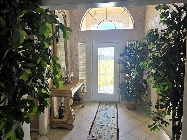 foyer with tile patterned floors and wallpapered walls