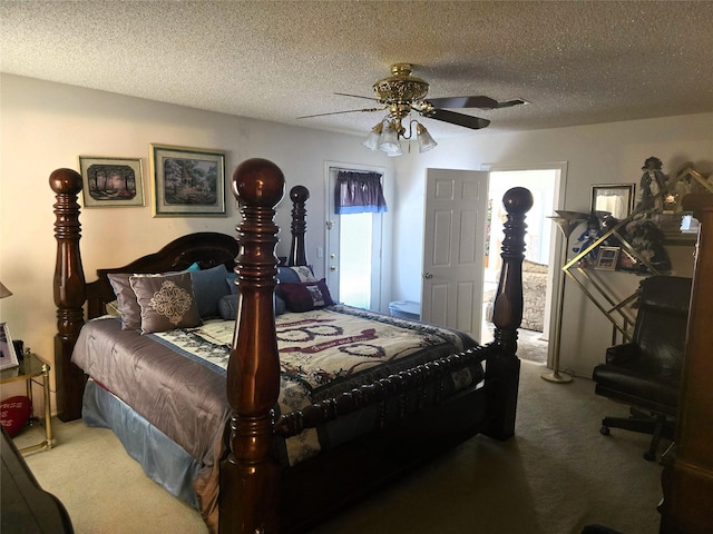 carpeted bedroom featuring ceiling fan and a textured ceiling