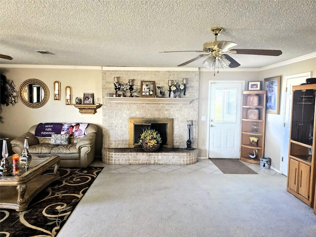 carpeted living room with a textured ceiling, visible vents, a fireplace, ornamental molding, and a ceiling fan