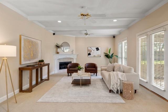 2034 Oak Glen Dr, Mcgregor, TX 76657 - living room featuring beamed ceiling, light colored carpet, a ceiling fan, a fireplace, and baseboards
